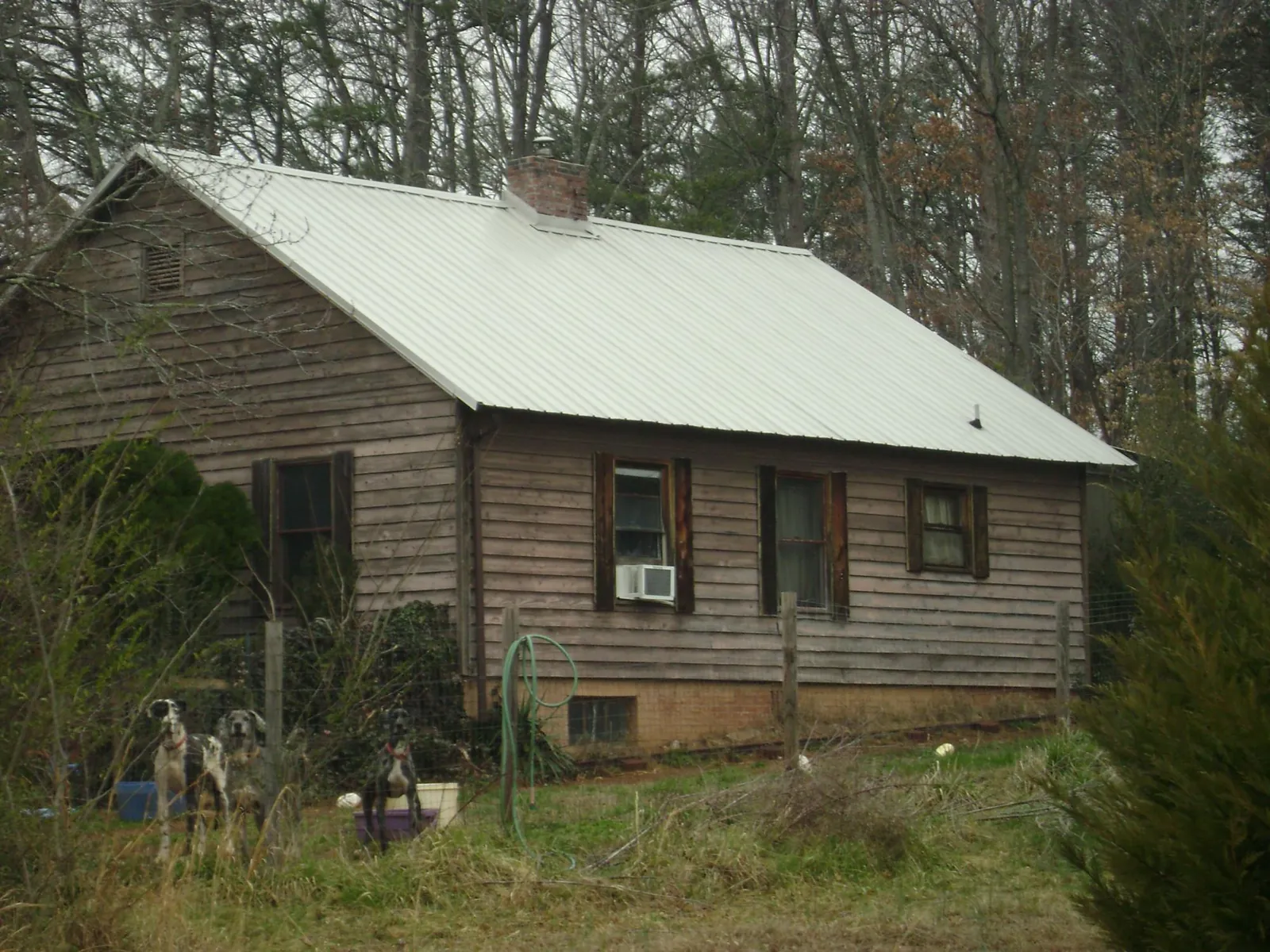 White metal roof on an old wood sided farmhouse, from a Metal Roof Installation job in North Judson